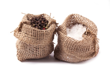 Tow sacks of salt and pepper over whiteの写真素材