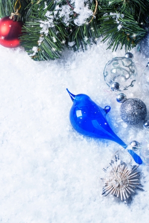 Christmas card with glass blue bird and christmas tree over snowの写真素材