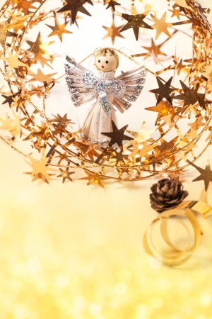 Christmas card with angel and golden stars with bokeh as backgroundの写真素材