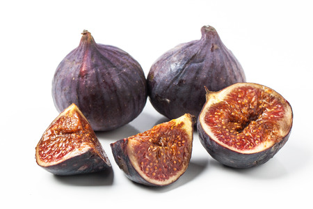 Close-up of sliced and whole figs over whiteの写真素材