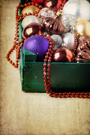 Wooden green box of christmas colorful toys over old textured backgroundの写真素材