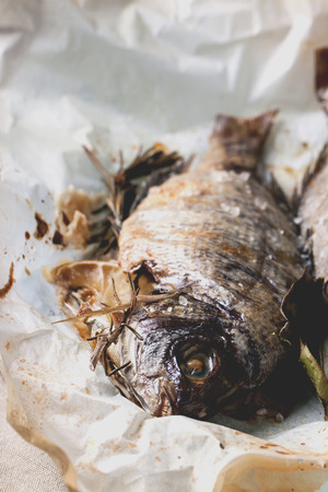 Grilled dorado fish with rosemary served on baking paper. の写真素材