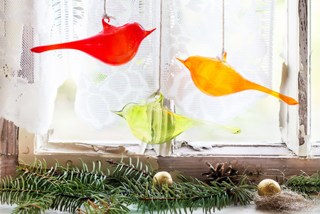 Fragment of interior on old windowsill with christmas tree and three glass birds. See seriesの写真素材