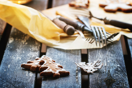 Christmas cookies on old wooden table with vintage cutleryの写真素材