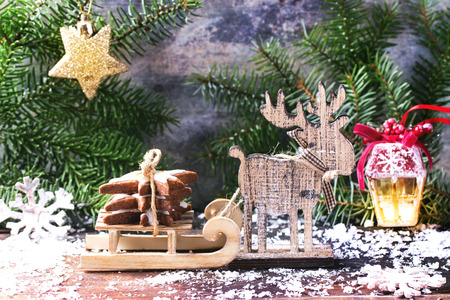 Christmas card with cookies in slade with Christmas tree, toys and snow.
