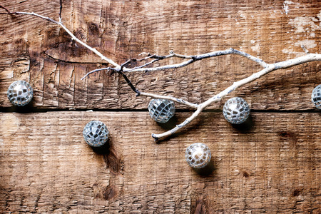 Christmas background with white branch and mirror balls on woodの写真素材