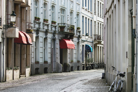Facades of old medieval buildings on the canals with swans of Brugesの写真素材