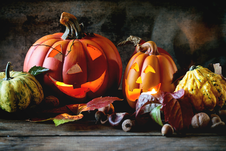 Halloween's pumpkins with autumn leaves on wooden table. See series.の写真素材