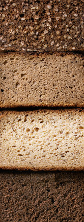 Variety loaves of sliced homemade rye bread whole grain and seeds. Top view, close up. Healthy...