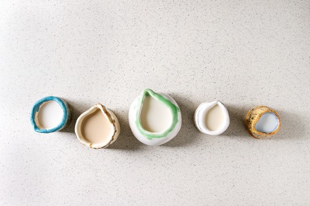 Variety of non-dairy vegan lactose free nuts and grain milk almond, hazelnut, coconut, rice, oat in...