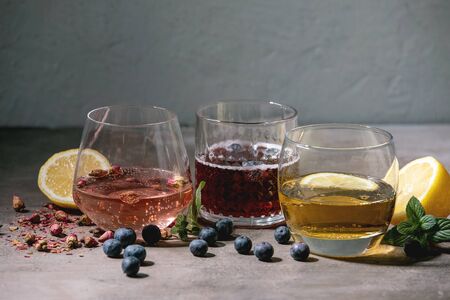 Different cocktail glasses with sparkling colorful drinks pink rose champagne, cider or lemonade...