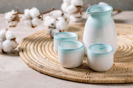 Sake ceramic set for traditional japanese alcohol drink rice wine sake, pitcher and three cups,...