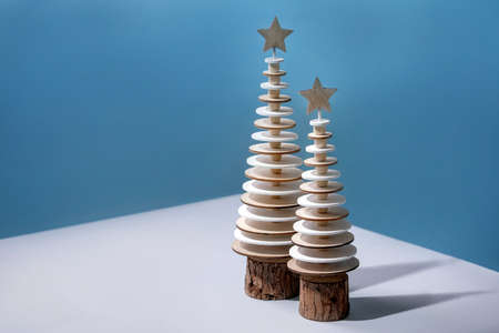 New year Cristmas greeting card with wooden trees over blue