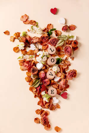 Beautiful botanical composition for st. Valentines Day. Creative layout with dry roses, petals,...