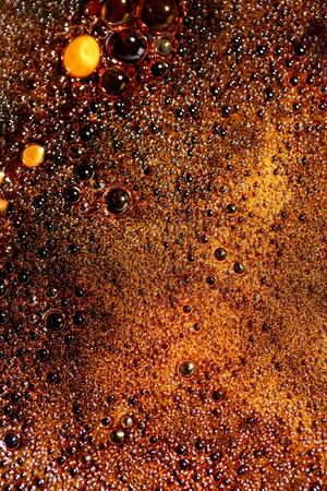 Abstract background of brown melted caramel in shape of planet landscape. Macro. Top view, flat lay....