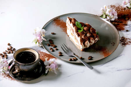 Slice of homemade gluten free tiramisu traditional italian dessert sprinkled with cocoa powder...