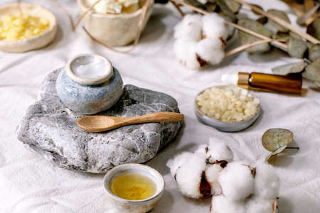 Ingredients for makes home made natural skin care cosmetic. Face cream in progress, essential and...