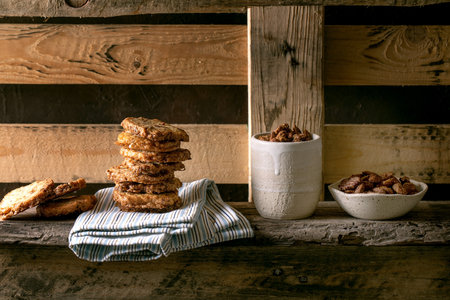 Sweet homemade snacks. Bowl of glazed honey roasted almond nuts and stack of square shortbread sugar...