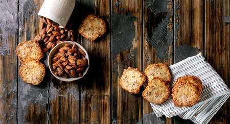 Sweet homemade snacks. Bowl of glazed honey roasted almond nuts and square shortbread sugar cookies...