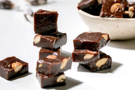 Homemade toffee salted caramel chocolate almond nuts candy on white table. Handmade food sweet gifts for any holidays.の写真素材