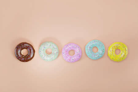 Top view of realistic glazed donuts 3d render. Donuts with different chocolate and fruit glazes and...