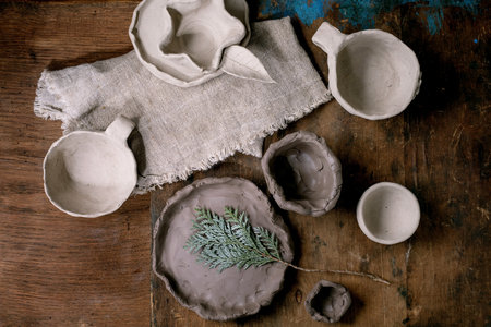 Ceramics workshop for children and beginners idea: flat plate made of raw clay featuring imprint of...