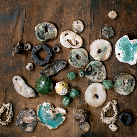 Various handmade ceramic beads. Hobby, jewelry assembly, DIY jewelry. Workshop idea. Dark wooden background, top view, copy spaceの写真素材