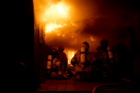 Firefighters training firefighting inside flash over containerのeditorial素材