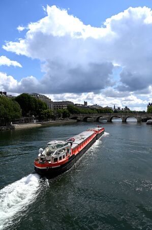 Long barge on the Seine river in Parisの写真素材