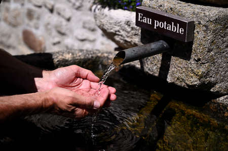 Man drinking water at the fountainの写真素材