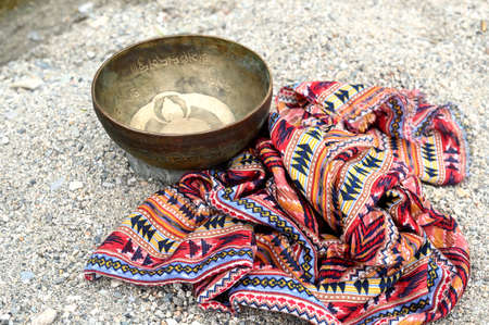 Tibetan singing bowl and scarf. Translation of mantras. transform your impure body, speech and mindの写真素材