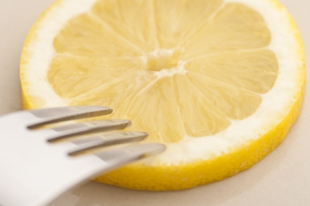 Extreme close up of a lemon and a forkの写真素材