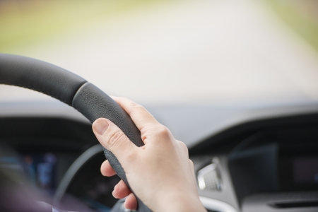Person driving a car with view of the road ahead blurred and area for copyspaceの写真素材