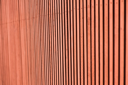 Seamless closeup of red wall on retro building. Striped wooden panels which make a nice surface with rough texture.の写真素材