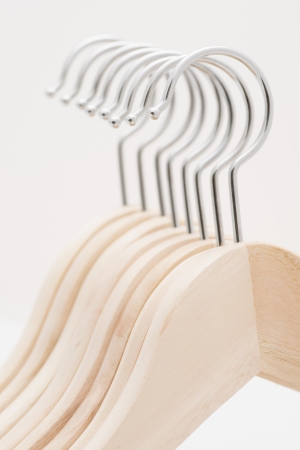 Detail of coat hangers made of wood in a rowの写真素材