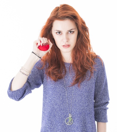 Portrait of angry woman squeezing a red stress ballの写真素材