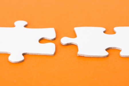 Close up of blank puzzle pieces on orange backgroundの写真素材