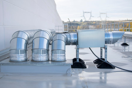 Air extractor and large galvanized steel pipes on the roof of a warehouseの写真素材