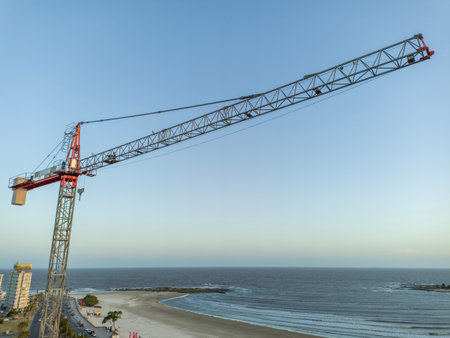 Cranes and buildings under construction by the seaの写真素材