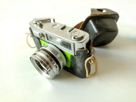 Nice green 35mm camera with lens on green background