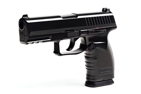 Black gun isolated on a white background. Close-up. Studio shot.の素材