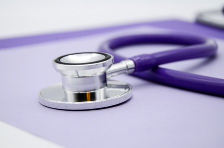 Stethoscope, stethophonendoscope on a purple background. Measurement of elevated pressure. Treatment to hypertensions. Medical flatly.の写真素材