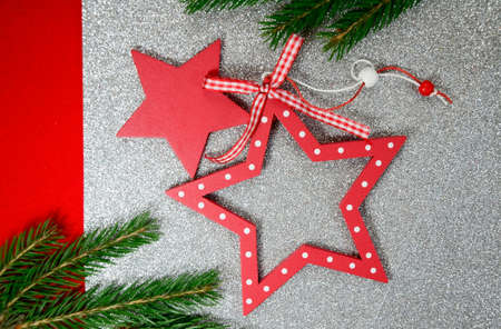 Red Christmas stars and green branch on silver background. Christmas flatly, New year 2022.の写真素材