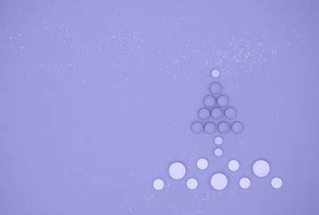 Medical pills in form of Christmas tree in snow in color of year 2022. Christmas medical flatly.の写真素材