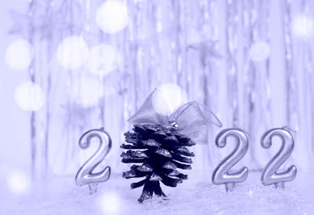 Number 2022 in color of year 2022 Very peri and cone with bow, bokeh, stars. Concept of Christmas,...
