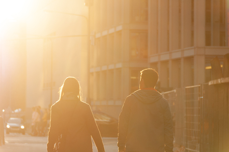 Couple walking in the sunsetの写真素材