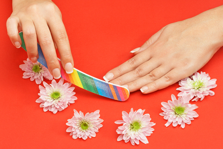 Female polishing her nails with nail fileの写真素材