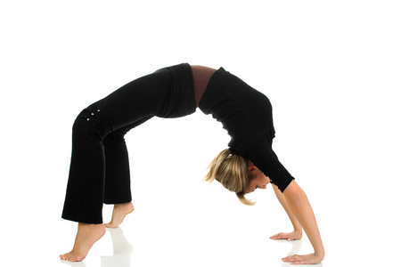Young beautiful girl making bridge isolated on white backgroundの写真素材