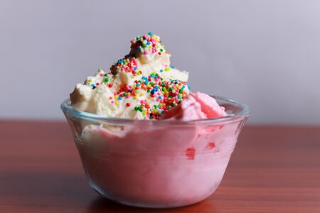 Vanilla and strawberry ice cream served in glasses, with sweet sprinkles and, Bogotá Colombia, February 15, 2017の写真素材