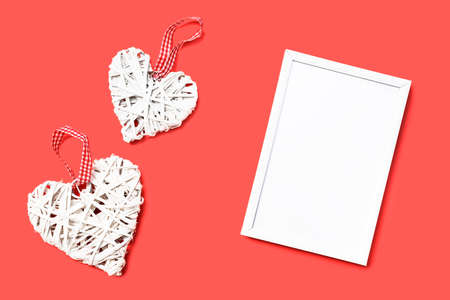 Heart-shaped toy and empty photo frame. Valentine's day mockup.の写真素材